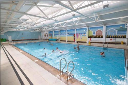 a group of people swimming in a large swimming pool at Seaview Caravan, Perran Sands in Perranporth