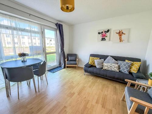 a living room with a couch and a table at Superb Chalet, Sleeps 8, Nearby Hemsby Beach In Norfolk Ref 18193B in Hemsby