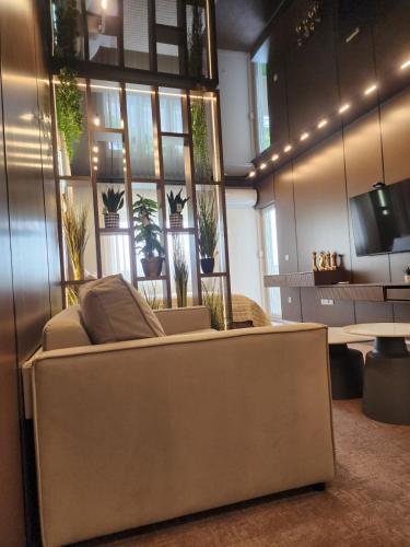 a living room with a couch in front of a window at Harmony Apartments in Podgorica