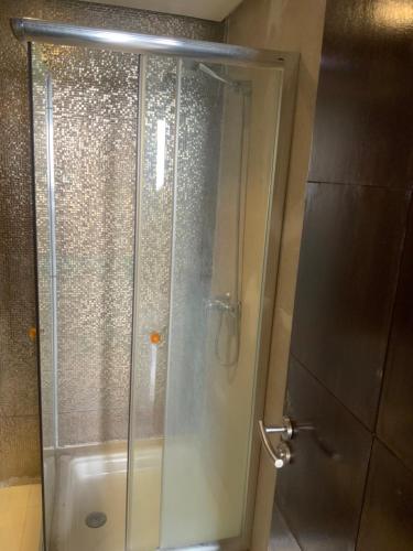 a shower with a glass door in a bathroom at Ecrin Moderne Islan a Agadir in Agadir