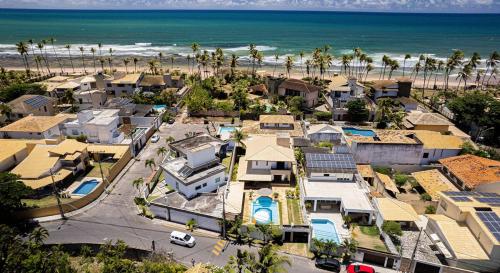 an aerial view of a residential neighborhood with the beach at Nossa Casa em Vilas - 70 m da areia - 6 Suítes in Lauro de Freitas