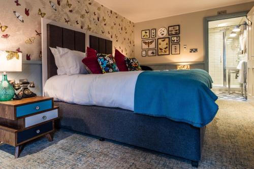 a large bedroom with a large bed and a table at Hand and Spear in Weybridge