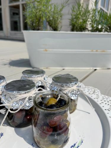 a glass jar filled with fruit on top of a table at Lavender Village in Kiemeliai