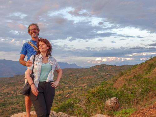 a man and a woman standing on top of a mountain at El Paraiso - B&B Finca San Vicente in Barichara