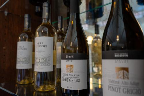 four bottles of wine sitting on a glass shelf at Hotel Villa Tripaldi in Schönberg in Holstein