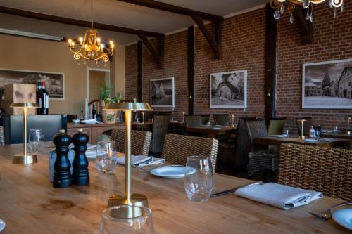 a dining room with a wooden table and chairs at Hotel Villa Tripaldi in Schönberg in Holstein
