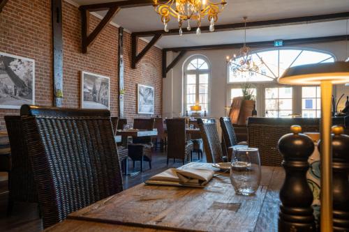 a dining room with a wooden table and chairs at Hotel Villa Tripaldi in Schönberg in Holstein