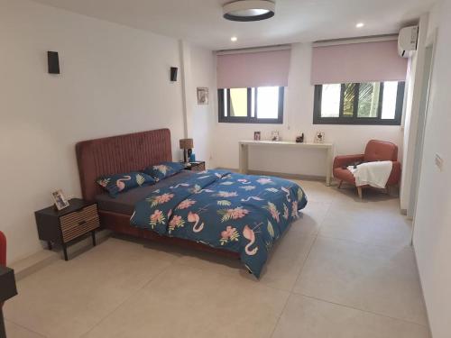 a bedroom with a bed and a desk and a chair at Furnished studio for rent in city in Dakar