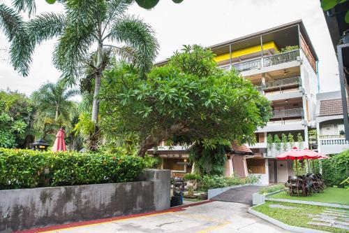 a building with a tree in front of it at Lantana Pattaya - SHA Extra Plus in Pattaya North