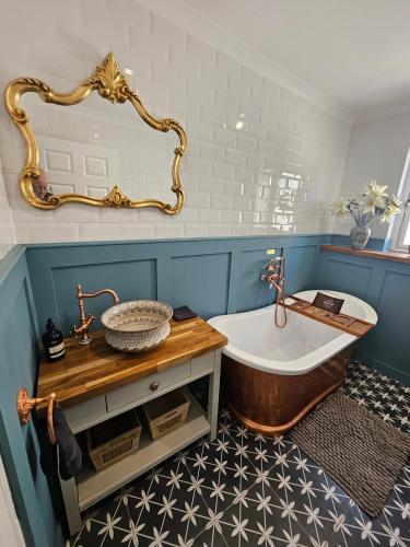 a bathroom with a tub and a sink at Braveheart Haven: 4BD Retreat with Hot Tub in Stirling