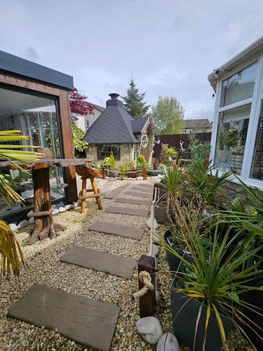 a garden with a pathway in front of a house at Braveheart Haven: 4BD Retreat with Hot Tub in Stirling