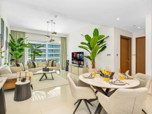 a living room with a table and chairs at Utra Lux Large 1 BR with Sunset Views and Private Beach in Dubai