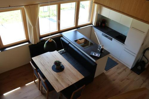 a living room with a couch and a wooden table at Appartement Bettina in Schoppernau