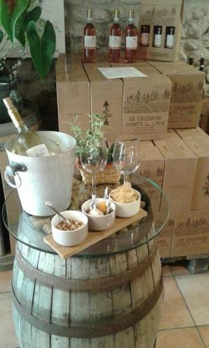 a wine barrel with wine glasses on top of it at Agriturismo Le Caldane in Colà di Lazise