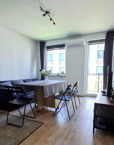 a living room with a table and chairs at Apartament "Cztery Pory Roku" in Świdnik