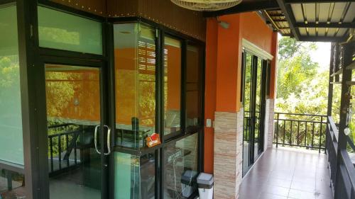 an outside view of a house with glass doors at Kaengkrachan River Hut in Kaeng Krachan