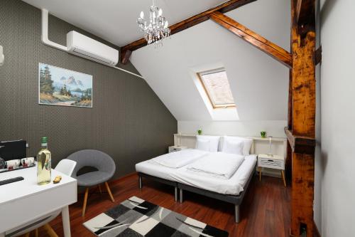 a bedroom with a bed and a desk in a room at Villa Fazola in Eger