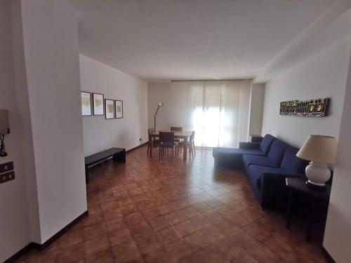 a living room with a blue couch and a table at Affittacamere Vetuliae Foligno in Foligno