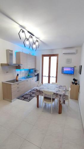 a kitchen with a table and a kitchen with a counter at Casa Braida in Muro Lucano