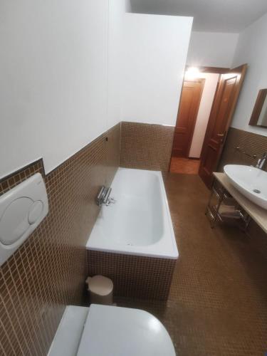 a bathroom with a tub and a toilet and a sink at Affittacamere Vetuliae Foligno in Foligno