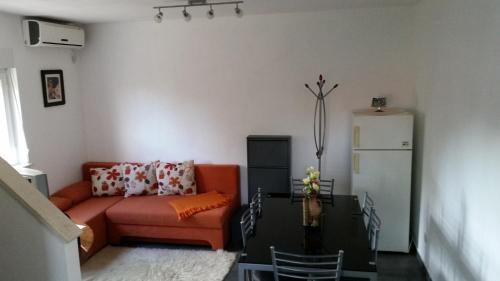 a living room with a couch and a table at Holiday Home White House in Sumartin