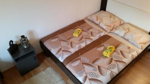 a bed with two toy cars on top of it at Holiday Home White House in Sumartin