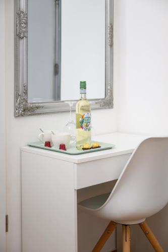 a white sink with a bottle and a chair at Villa Fazola in Eger