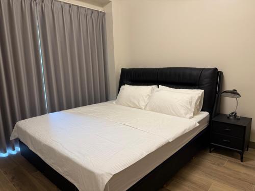 a bed with a black headboard in a bedroom at Luxurious Modern Cozy Manila Bayview Pool View 1 2 3 Bedrooms Near Manila Airports Okada Solaire MOA in Manila