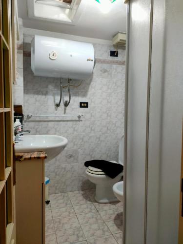 a bathroom with a toilet and a sink at A Za' Nella Avola in Avola