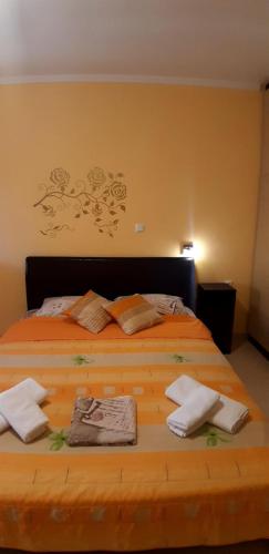 a bedroom with a large wooden bed with towels on it at Βlue Horizon Lixouri in Lixouri