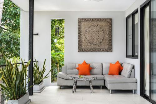 a living room with a couch and a table at Serene Escape at Asia Blue Villa One - Your Luxurious 3-Bed Villa Retreat Awaits in Salad Beach