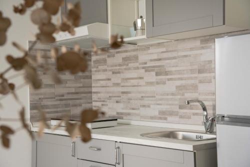a kitchen with a sink and a counter top at Blumarine Residence Club in Ostuni
