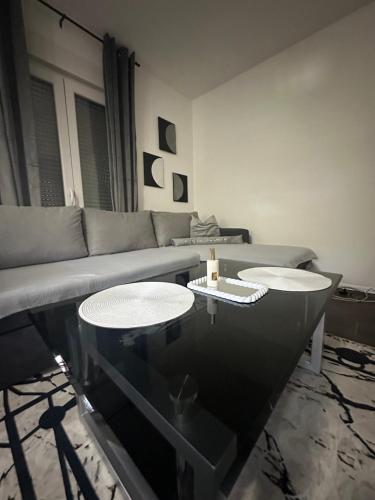 a living room with a couch and two tables at Magic Aria Bihac in Bihać