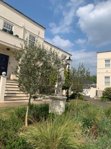a statue in front of a white building at Modern Regency Townhouse London in London