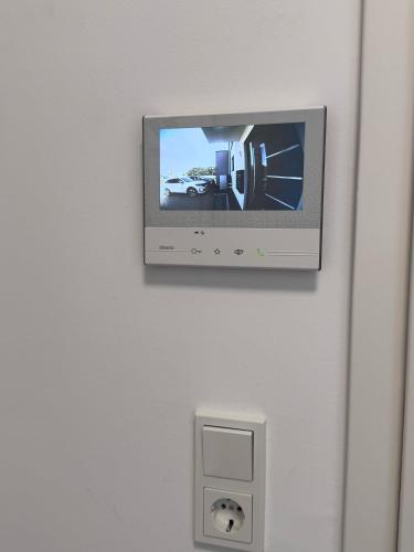 a flat screen tv hanging on a wall at Ferienwohnung Dariana Schwalbach/Saar in Schwalbach