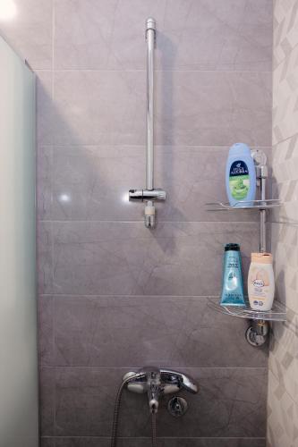a bathroom with a sink and a shower stall at Lux 010 in Pirot