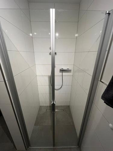 a shower with a glass door in a bathroom at Wohnglück Leer-Altstadt in Leer
