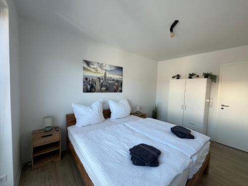 a bedroom with a bed with two bags on it at Wohnglück Leer-Altstadt in Leer
