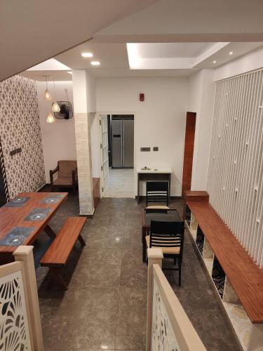 a room with benches and a table and a desk at Live On Cloud 9 at Kochi in Kakkanad