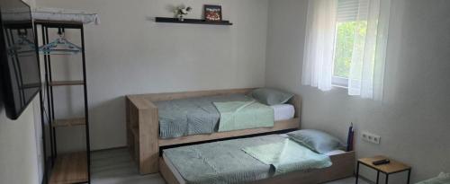 a bedroom with two bunk beds and a window at Vila V & S in Star Dojran