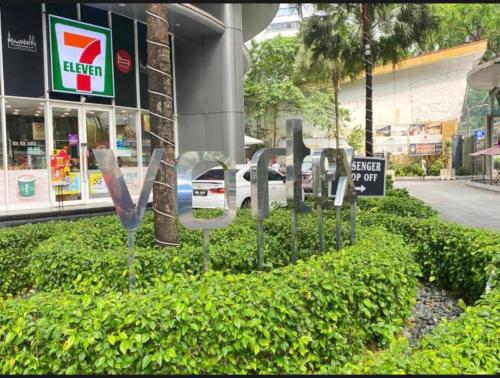 a sign for a store in front of a building at Vortex Premium Apartment klcc in Kuala Lumpur