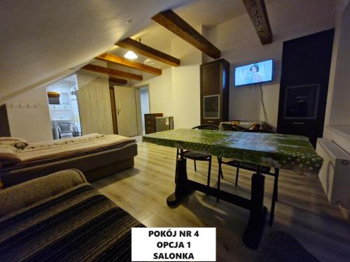 a room with a bed and a table in it at Dulkowa Zagroda in Gdańsk