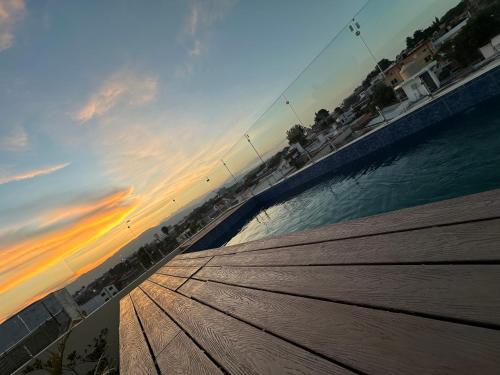 a view of a pier with a sunset in the background at Sky Garden in Guatemala