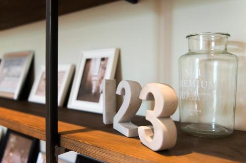 a wooden table with a sign and a glass jar at Palau de la Musica Apartments in Barcelona