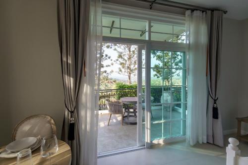 a sliding glass door leading to a patio with a table at CastellStay in Campson
