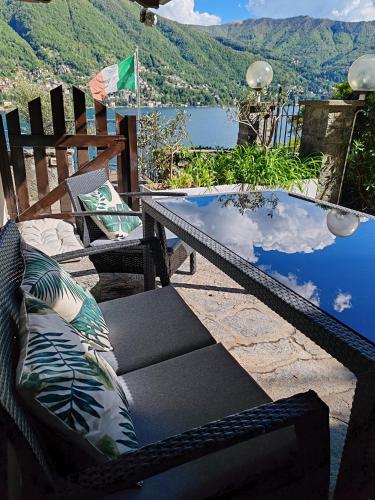a patio with chairs and a table with a view at Hotel Bersagliere in Laglio