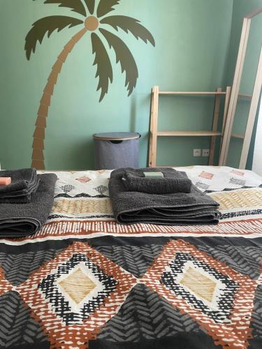 - une chambre dotée d'un lit avec un palmier sur le mur dans l'établissement Appartement calme avec vue montagnes marseille, à Marseille