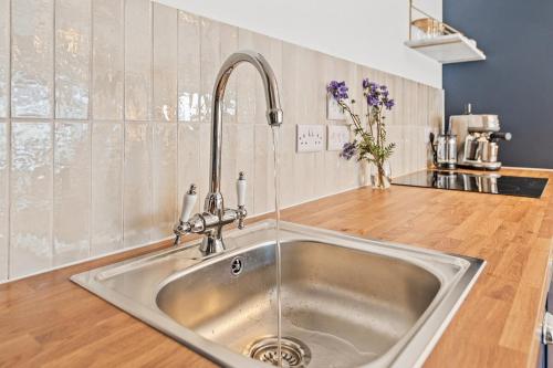 a kitchen with a stainless steel sink in a kitchen at Luxury 2 Bed cottage in Killin in Killin
