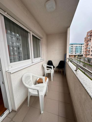 a balcony with two chairs and a window at Istocno Sarajevo-Hilandarska, Stan na dan SV in Donje Mladice