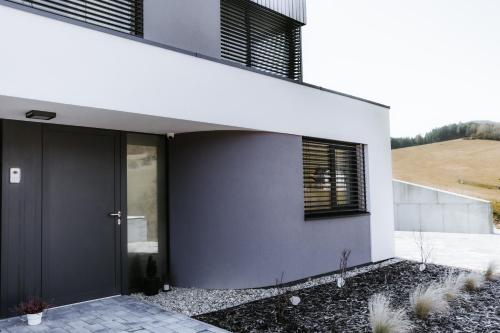a modern house with a black door at Apartmán Denali in Súľov
